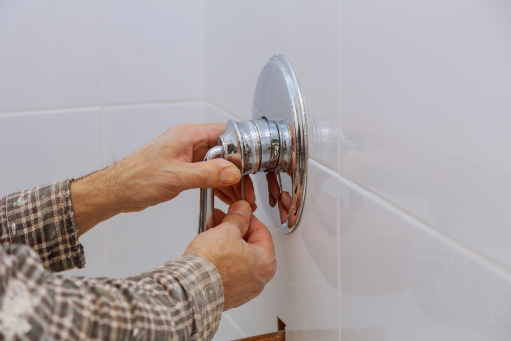 a man Tighten the Handle of shower faucet